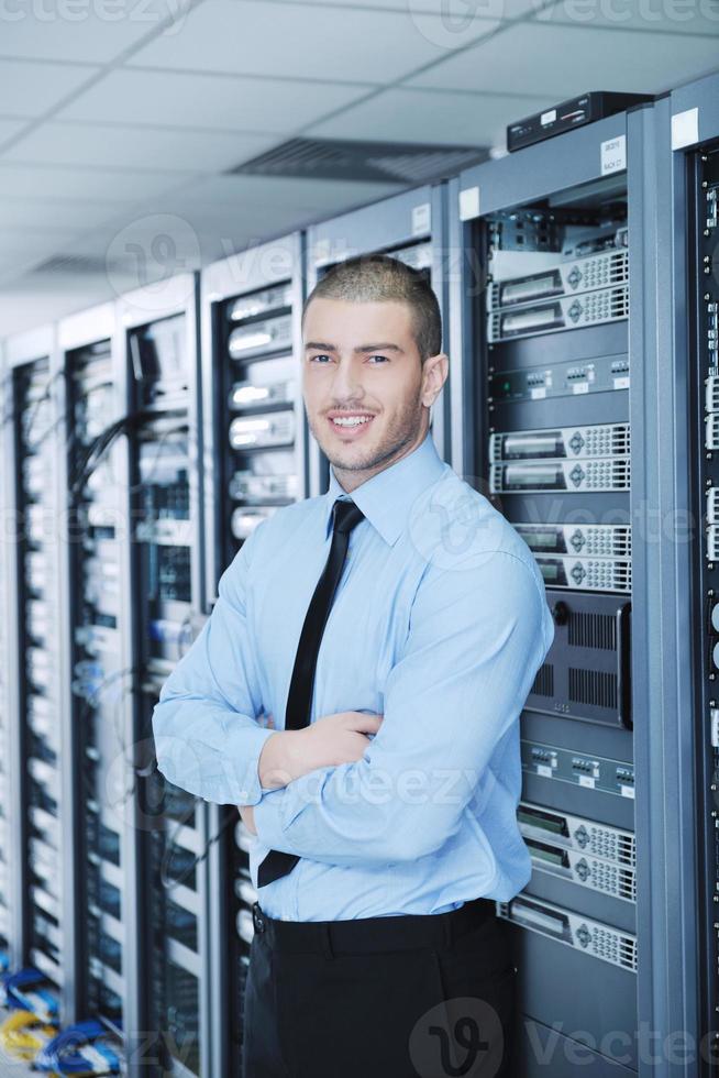 young it engineer in datacenter server room photo
