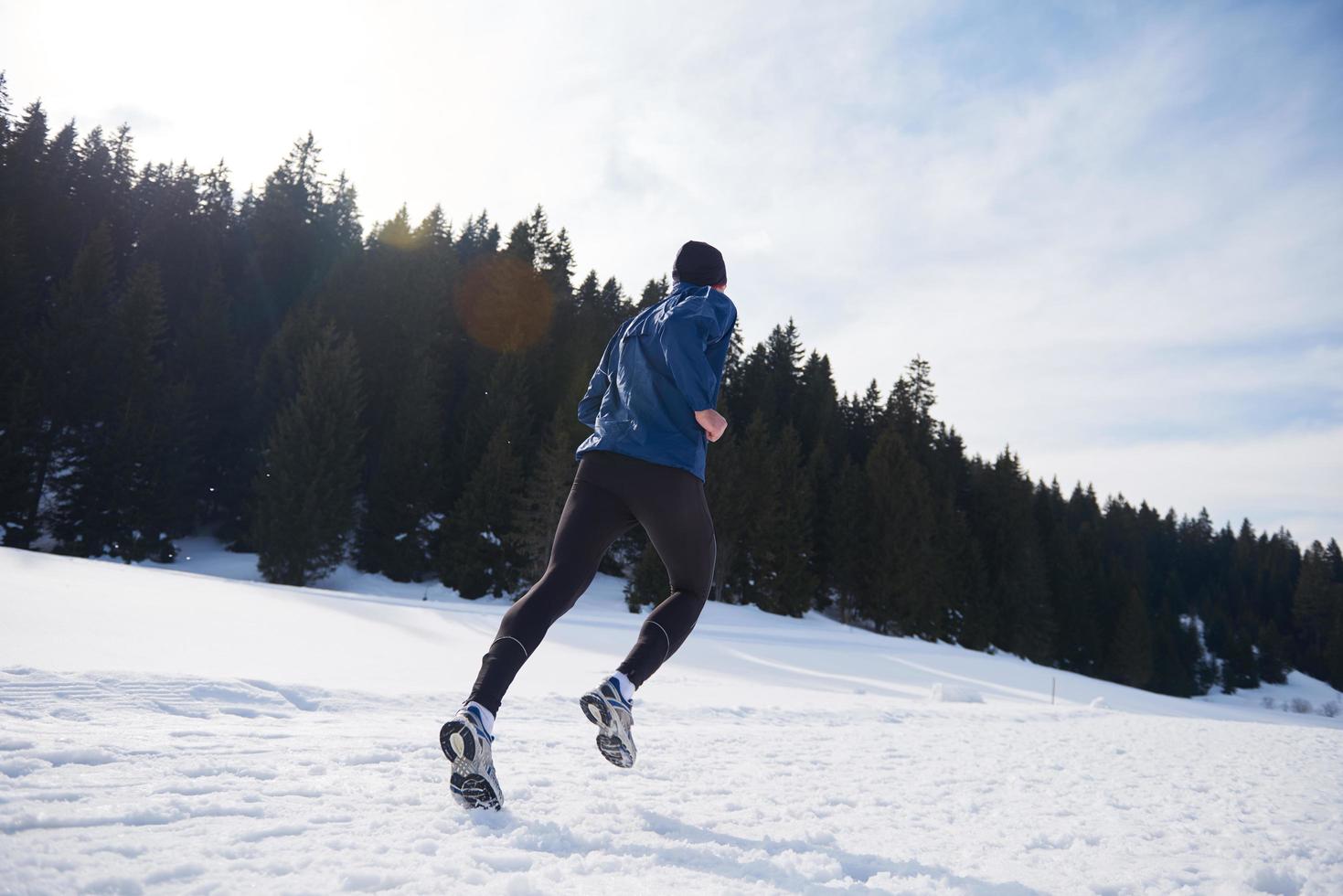 jogging on snow in forest photo