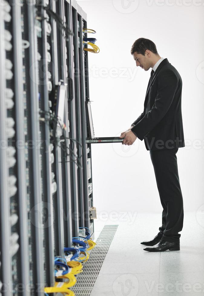 young engeneer in datacenter server room photo