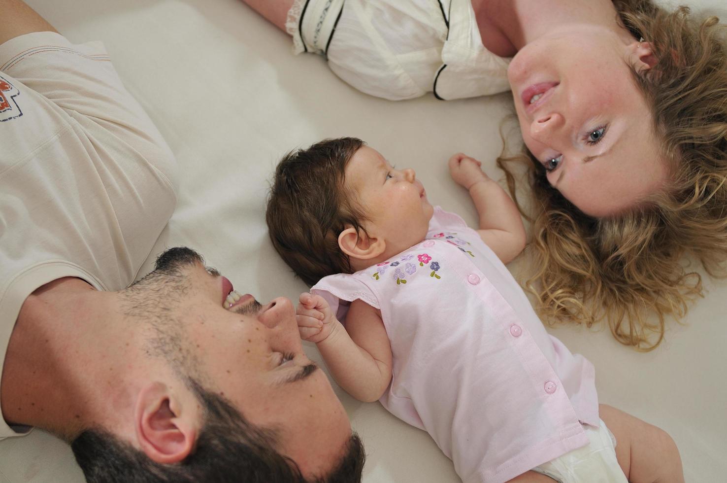 young family playing with cute little baby photo