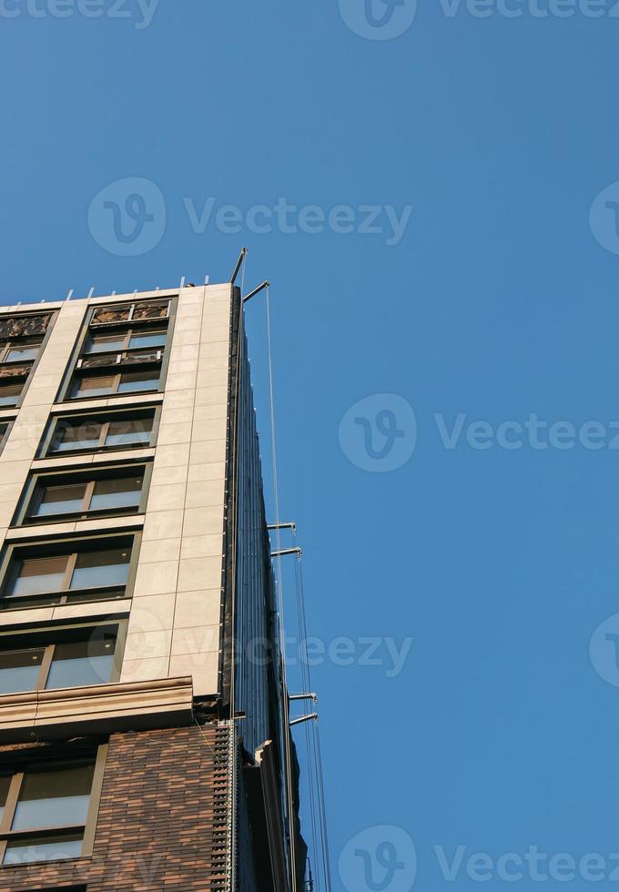 Construction crane against the blue sky. The real estate industry. A crane uses lifting equipment at a construction site. photo