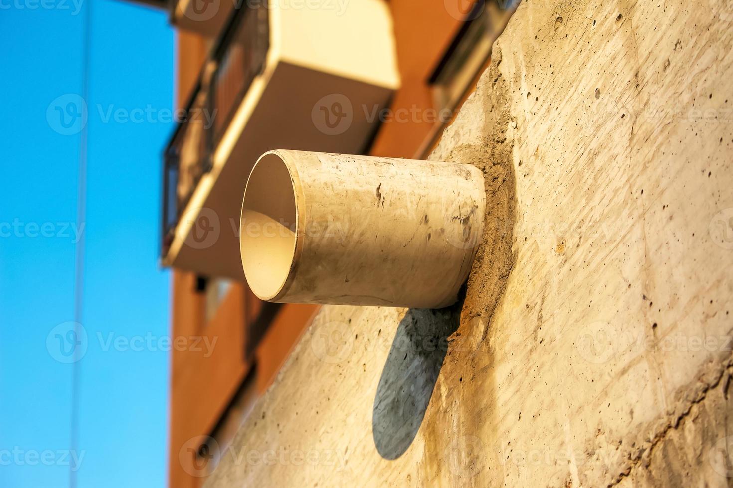 Extract from the pipe on the wall of the house. Preparing your home for a cold winter. Energy crisis. Extraction of exhaust gases. photo