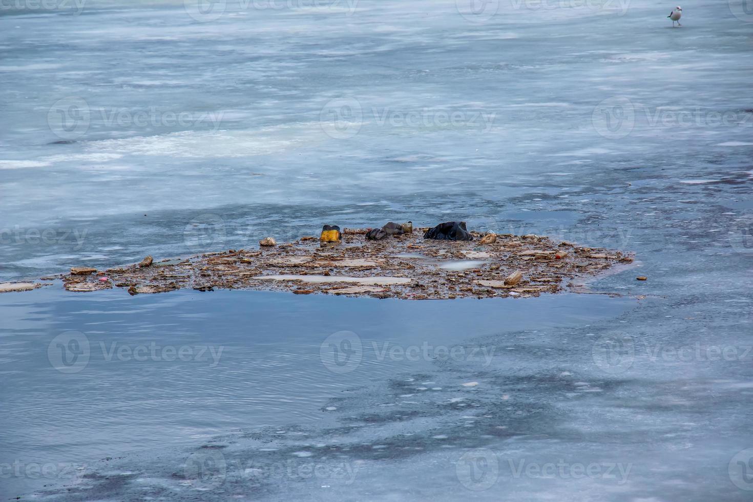 Background of the icy surface of the river with a small island. Texture of ice covered with snow. Winter background. photo