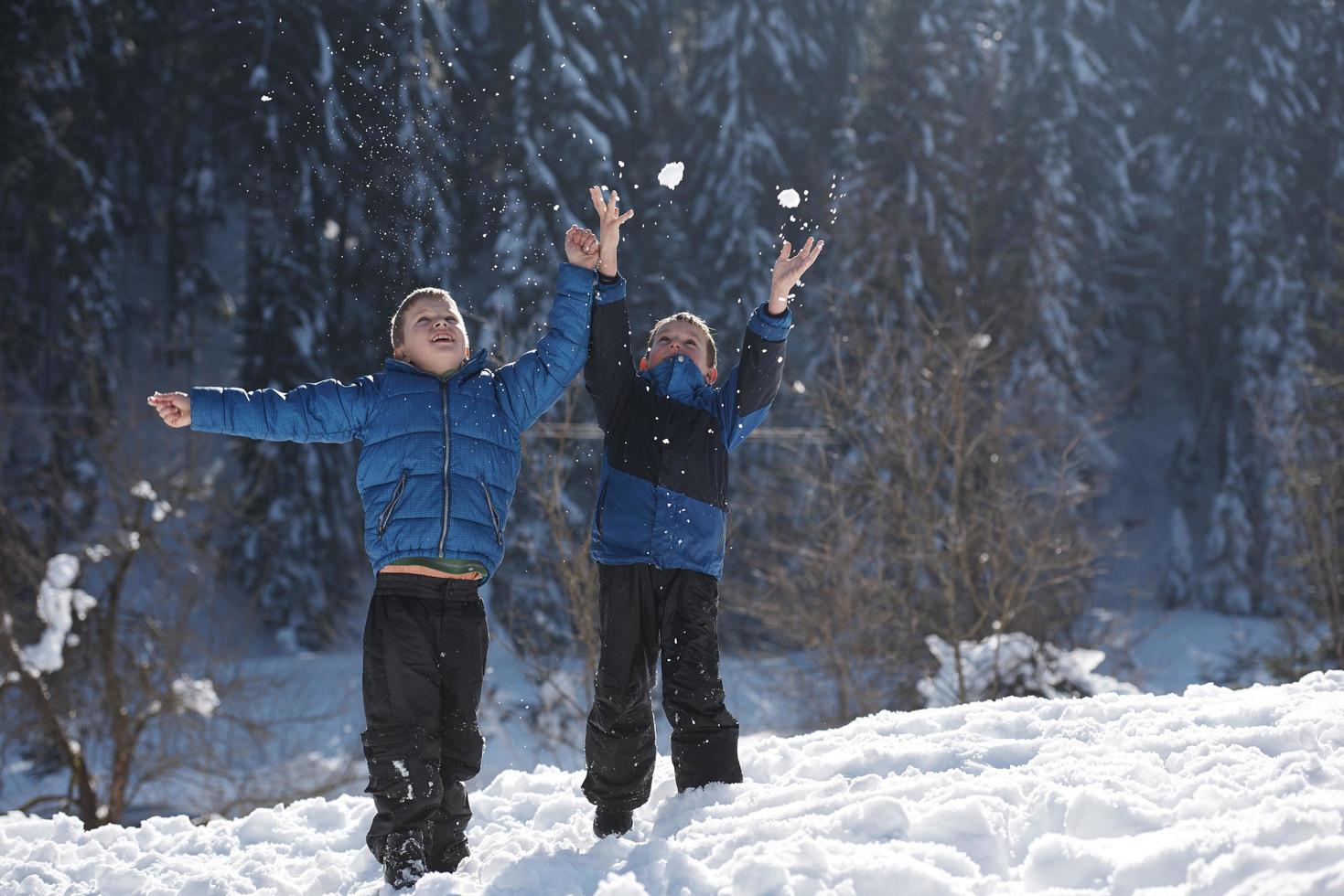 kids playing with  fresh snow photo