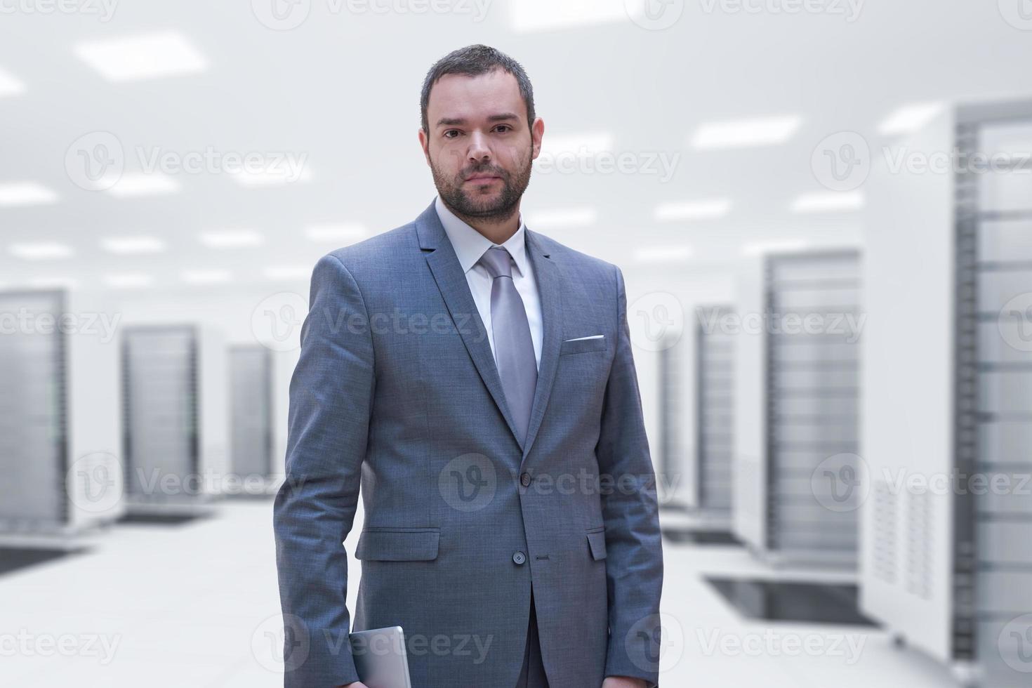 Young businessman in server room photo