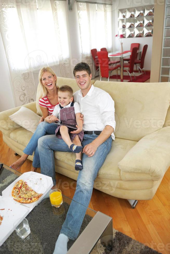 family at home using tablet computer photo