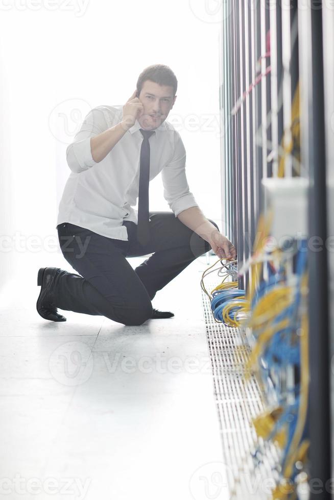 it engeneer talking by phone at network room photo