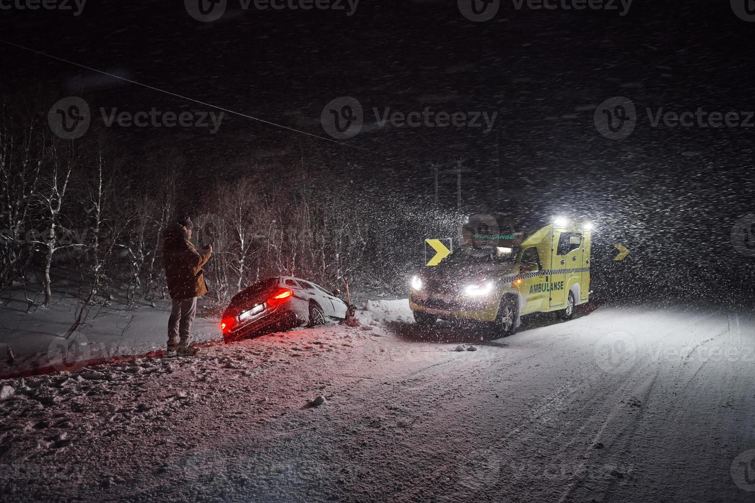 car accident on slippery winter road at night photo