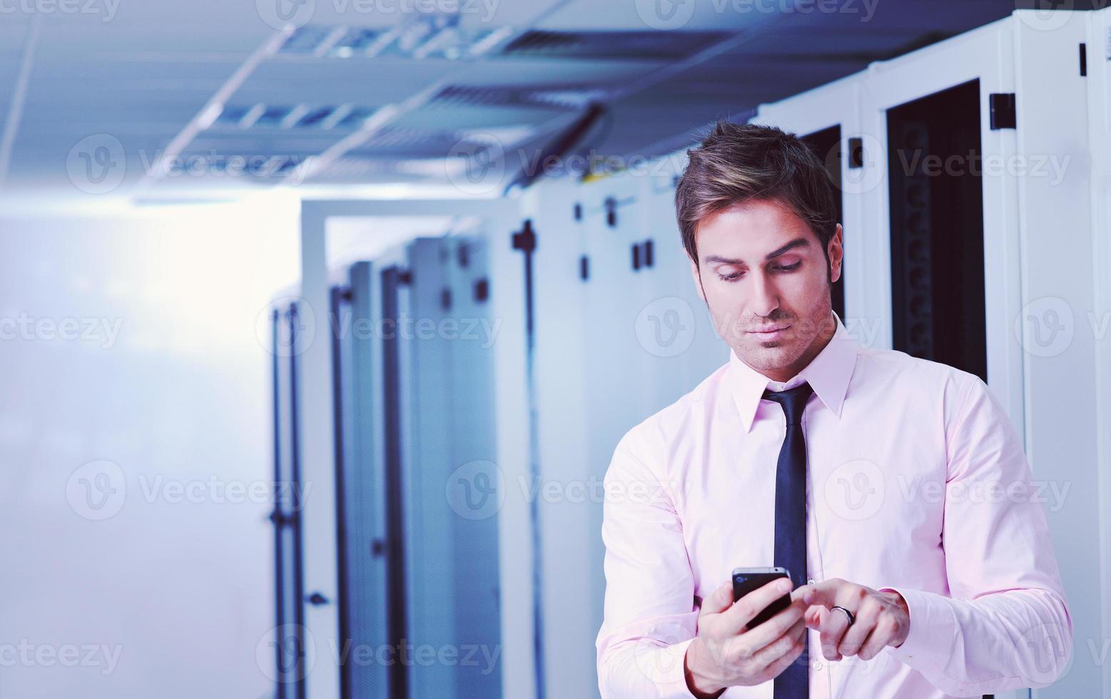 it engeneer talking by phone at network room photo