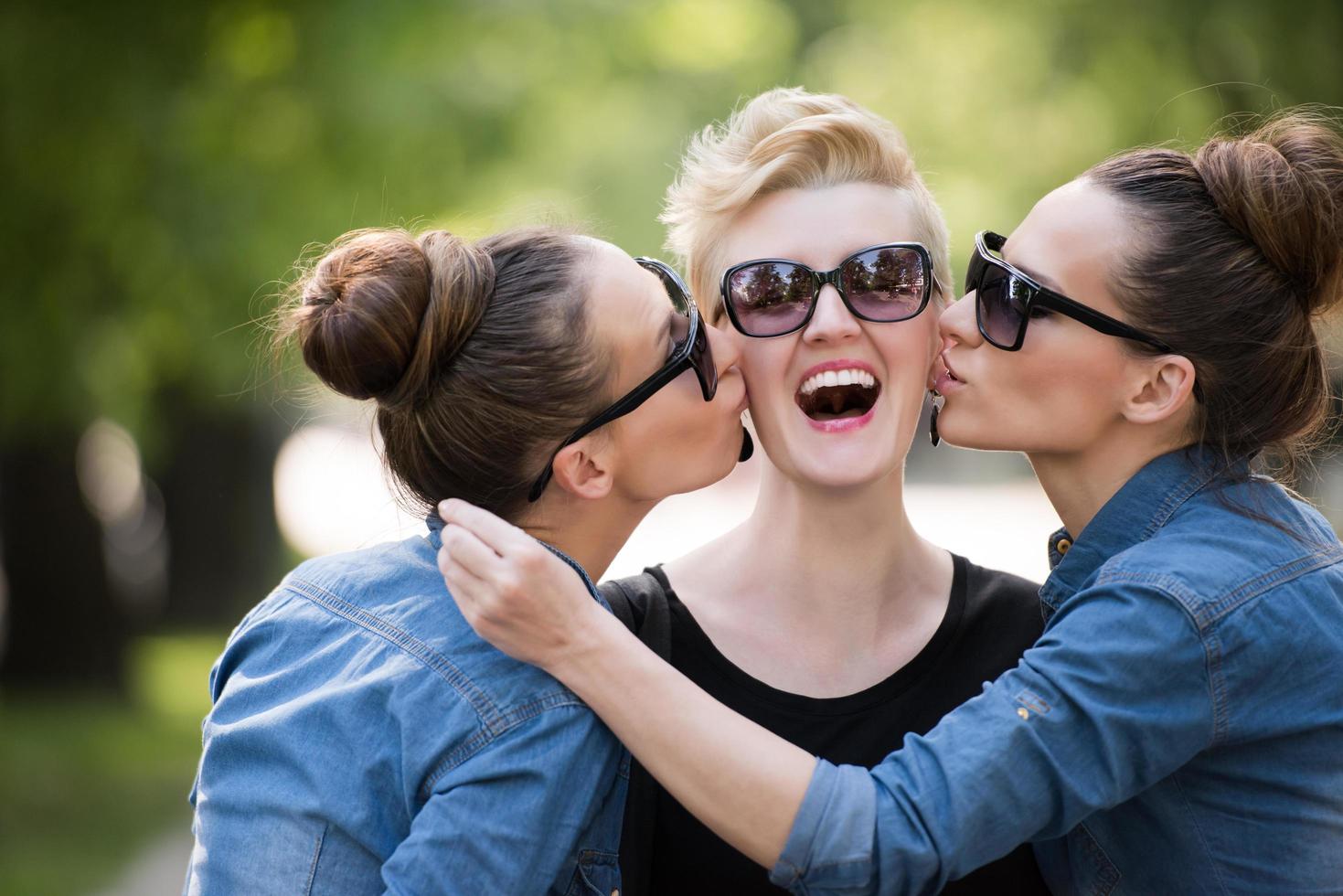 portrait of three young beautiful woman with sunglasses photo
