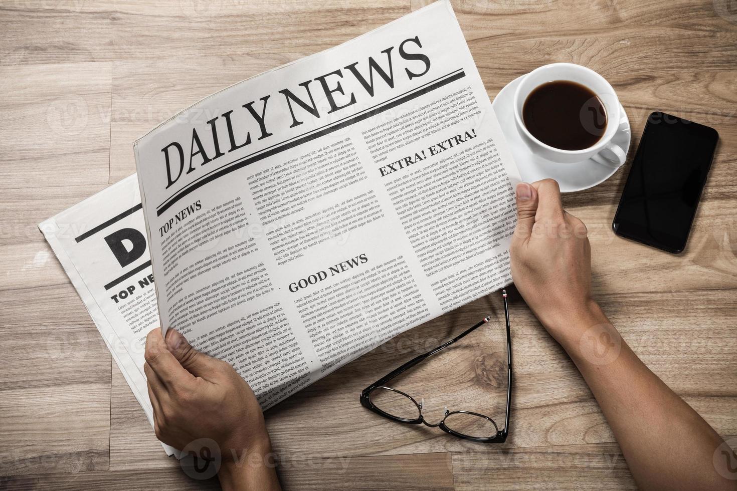 Hands holding the Business Newspaper on wooden table, Daily Newspaper mock-up concept photo