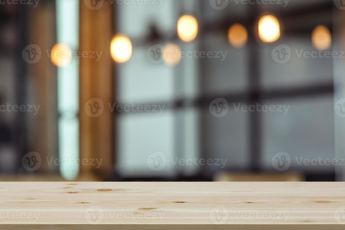 Empty wooden table top with view of room or wooden desk with restaurants with blur background, copy space for your text photo