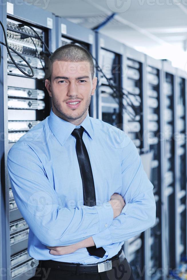 young it engineer in datacenter server room photo