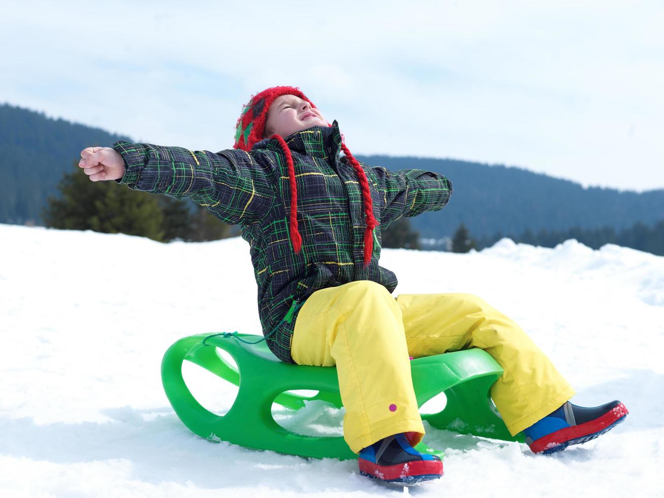 happy young boy have fun on winter vacatioin on fresh snow photo