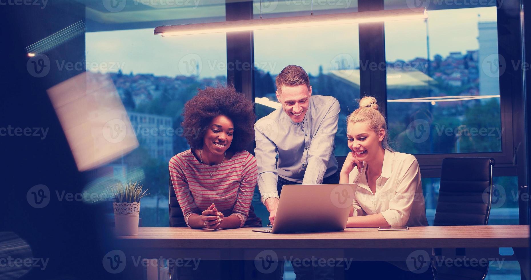 Multiethnic startup business team in night office photo