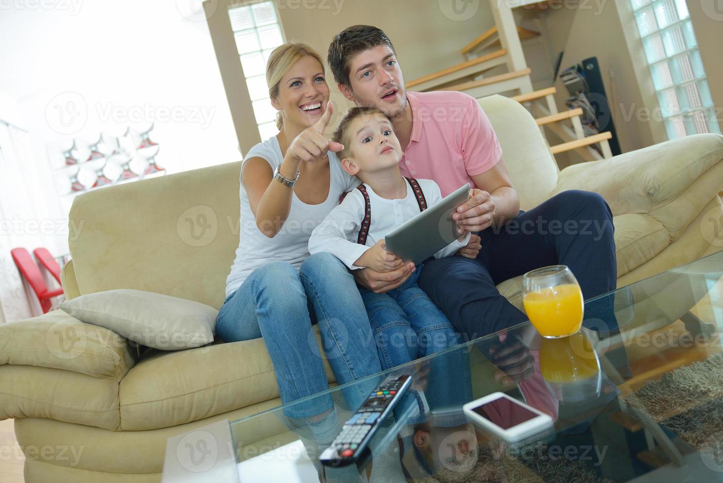 family at home using tablet computer photo
