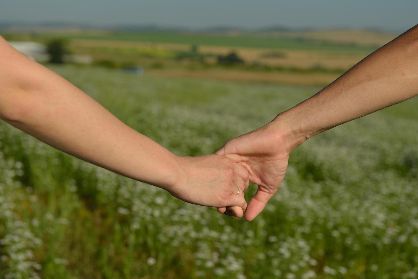 Holding hands outside photo