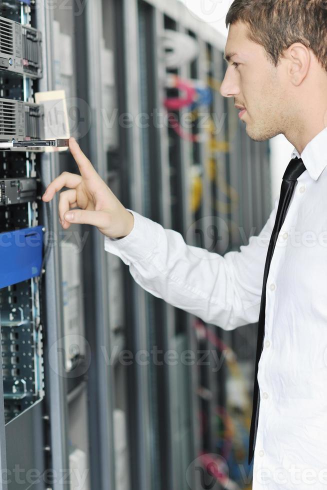 young it engeneer in datacenter server room photo