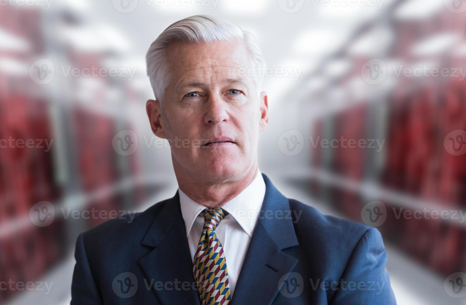 Senior businessman in server room photo