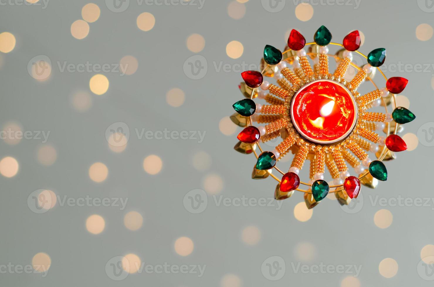 Diya lamp lit on white background with bokeh lights. Diwali festival concept. photo
