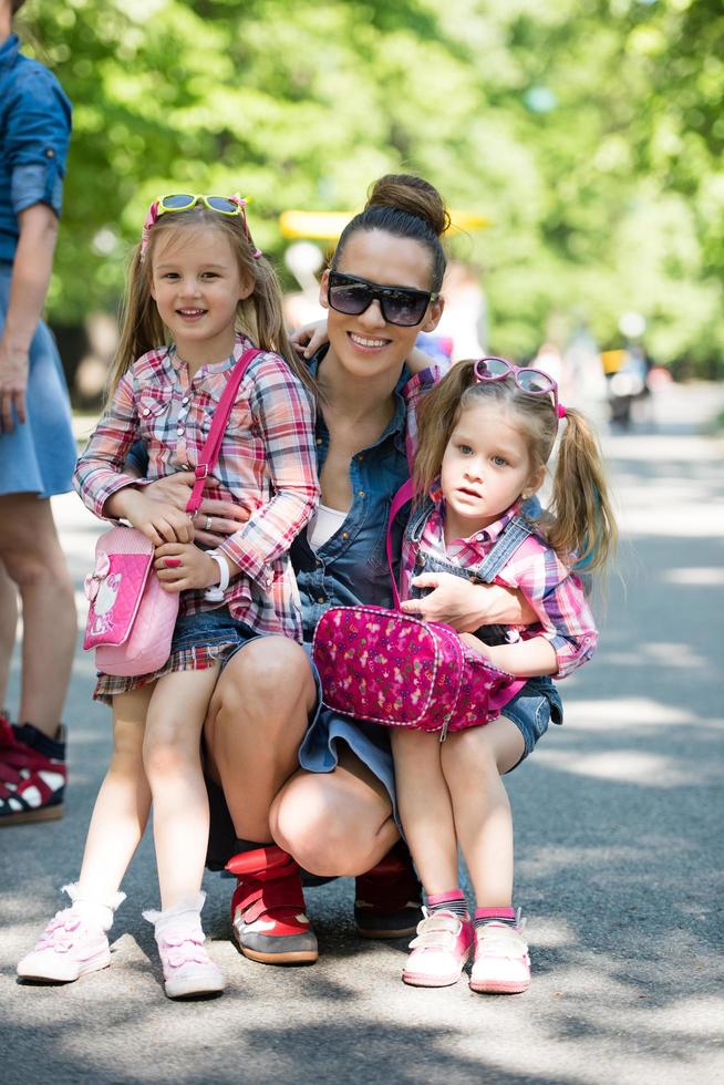 mother with her daughters in the park photo