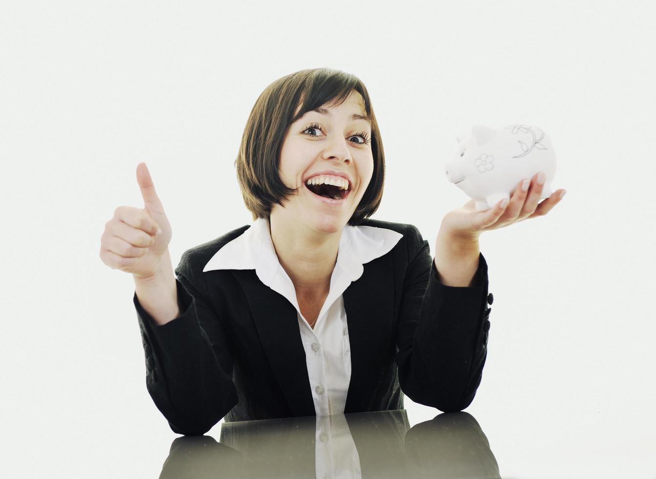 business woman putting coins money in piggy bank photo