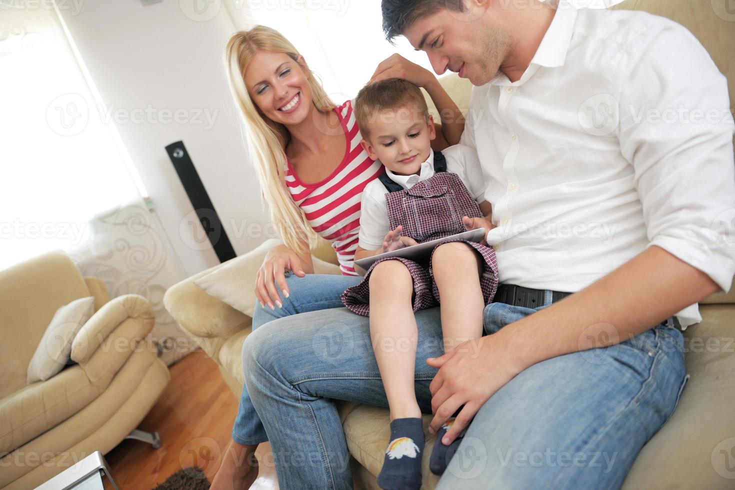 family at home using tablet computer photo