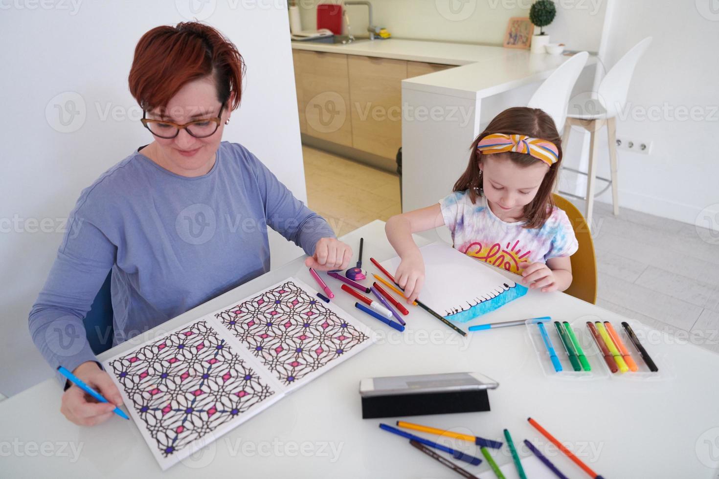 Mother and little daughter  playing together  drawing creative artwork photo