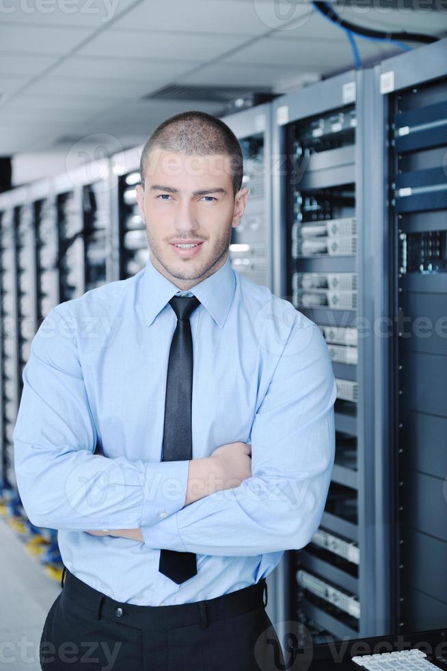 young it engineer in datacenter server room photo