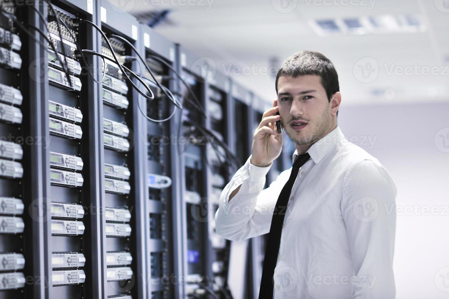 it engeneer talking by phone at network room photo