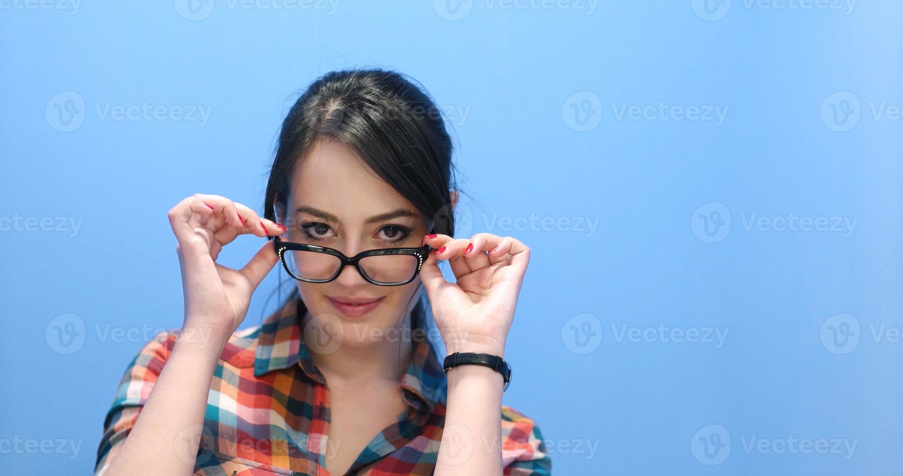 woman smiling wearing on a pair of large glasses photo