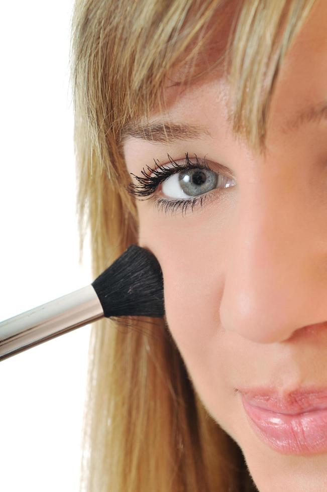 Woman applying makeup photo