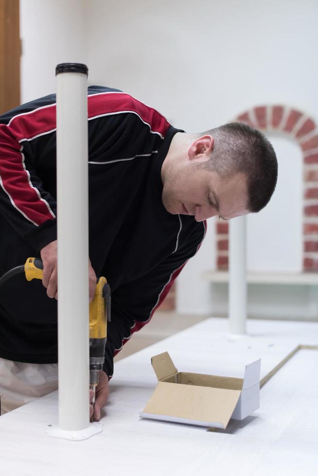 repairman working with drilling machine photo