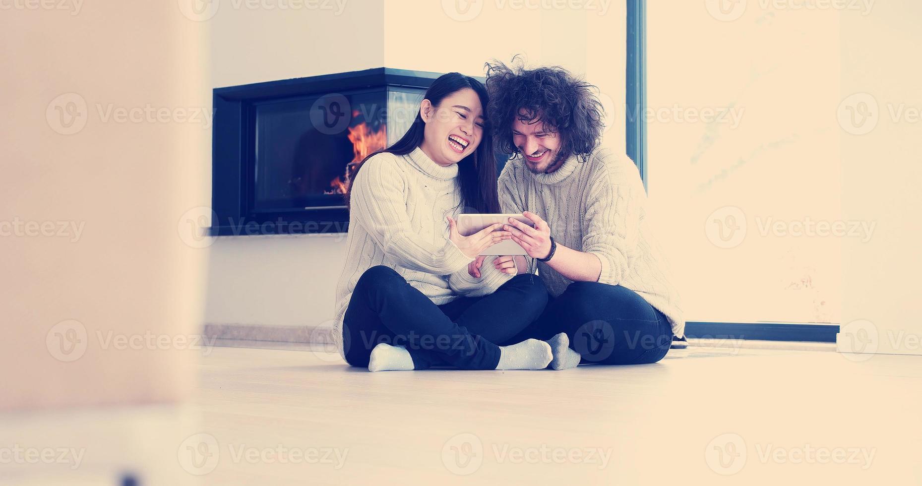 Young Couple using digital tablet on the floor photo