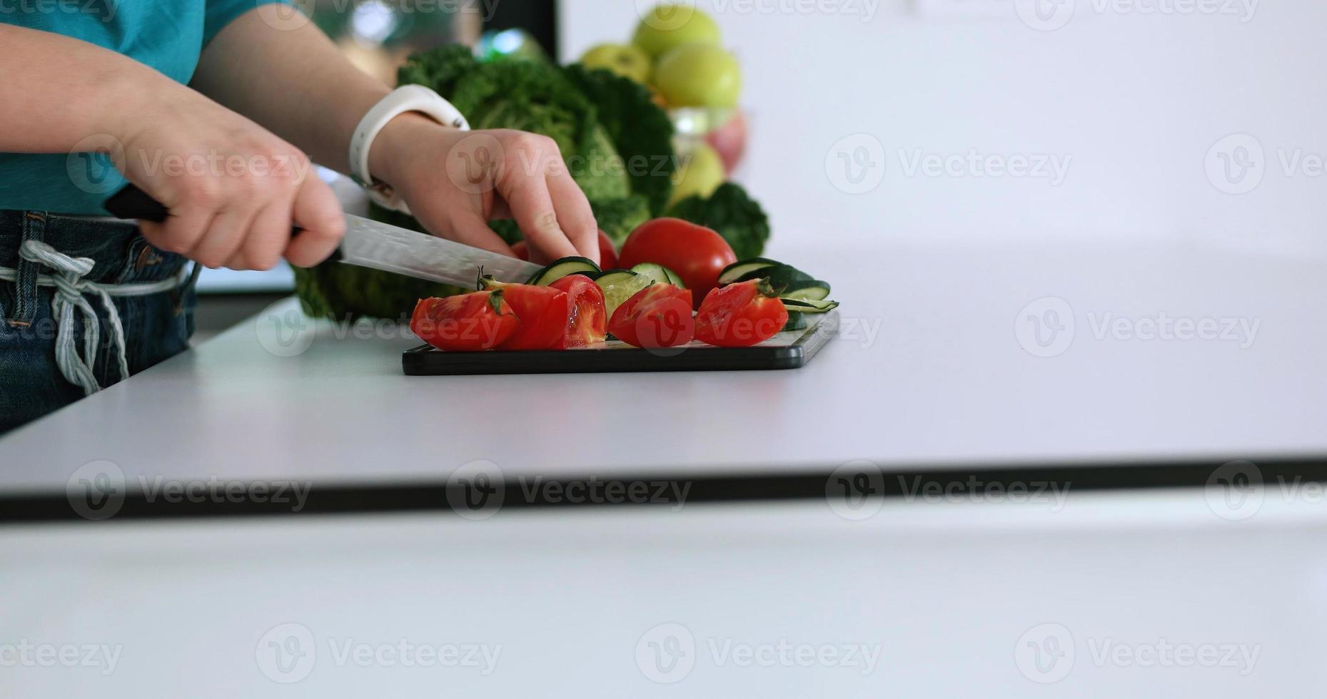 Young Couple In Modern Kitchen  Preparing Food photo