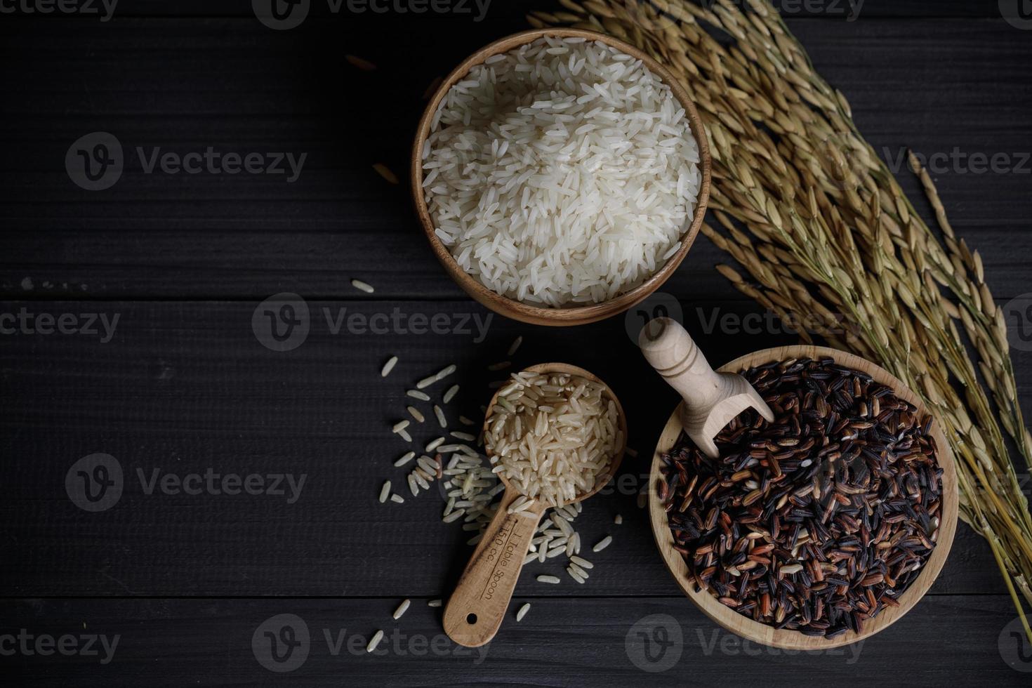 Sheaf yellow rice and white rice and organic jasmine rice on wooden table photo