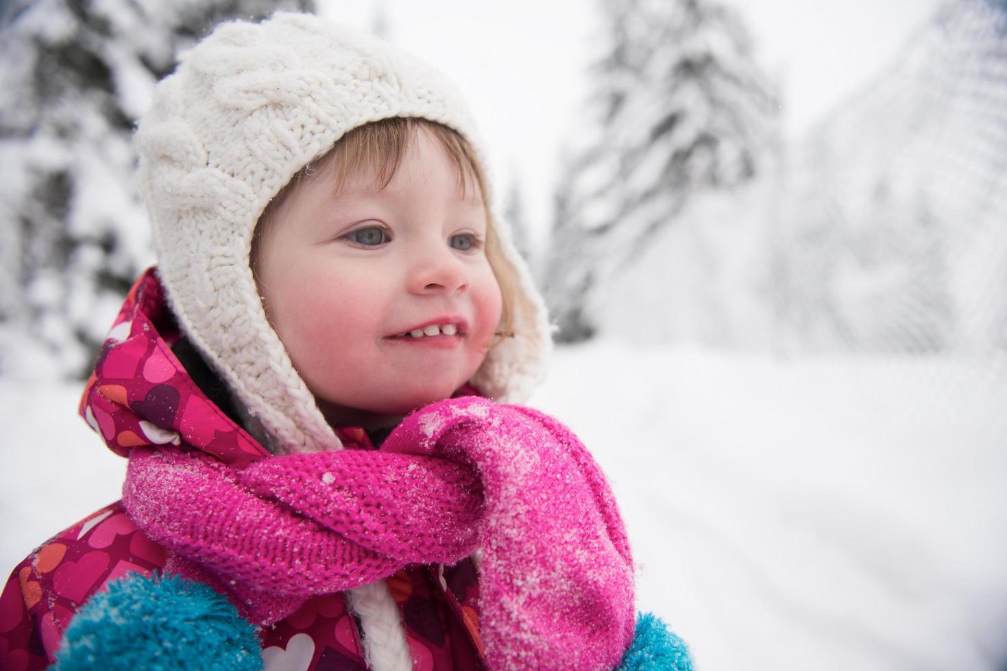 little girl have fun at snowy winter day photo