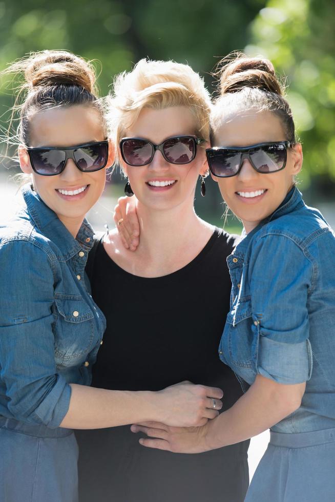 portrait of three young beautiful woman with sunglasses photo