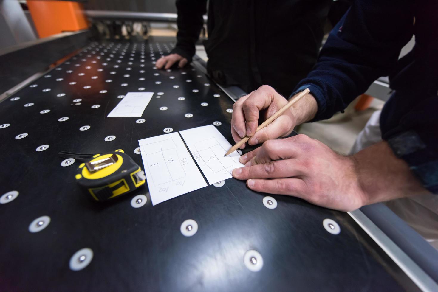 carpenters calculating and programming a cnc wood working machine photo