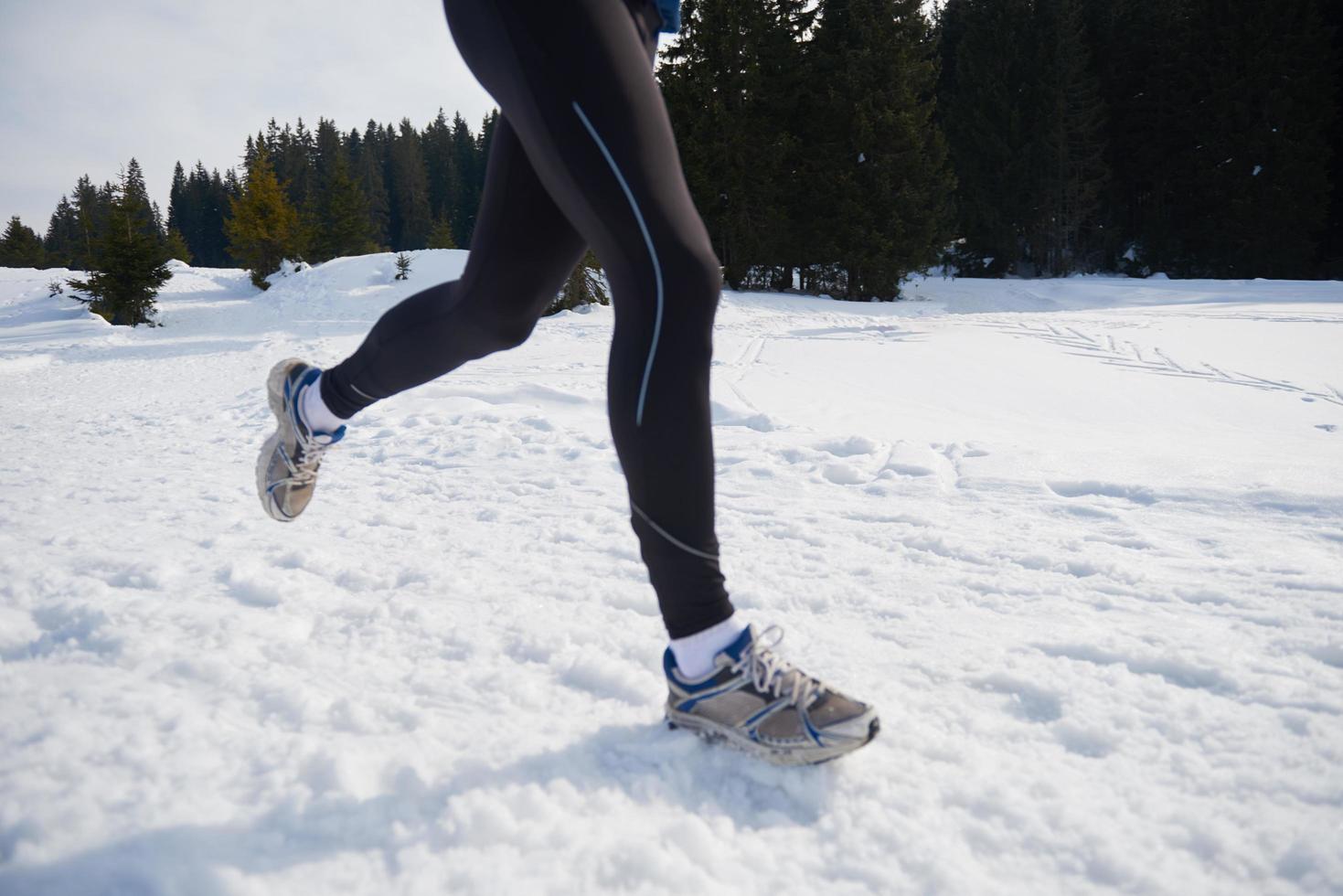 jogging on snow in forest photo