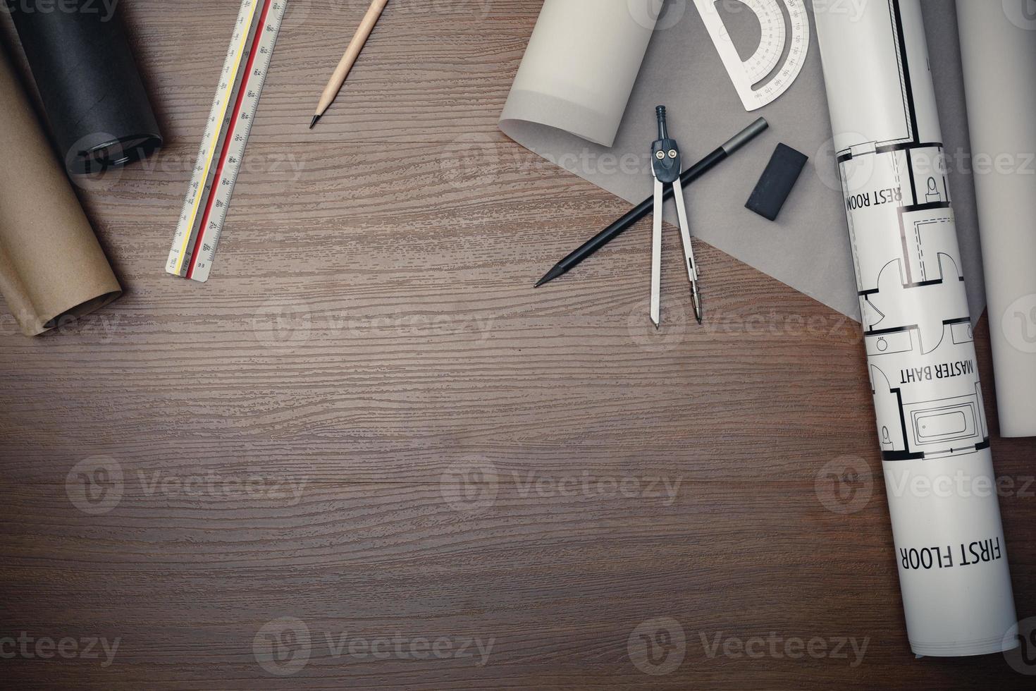 Top view workspace mockup of architectural project with laptop computer, architectural project plan, engineering tools, office supplies and hot coffee cup on wooden desk empty space photo