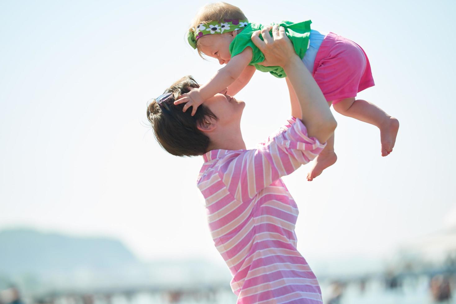 mom and baby on beach  have fun photo