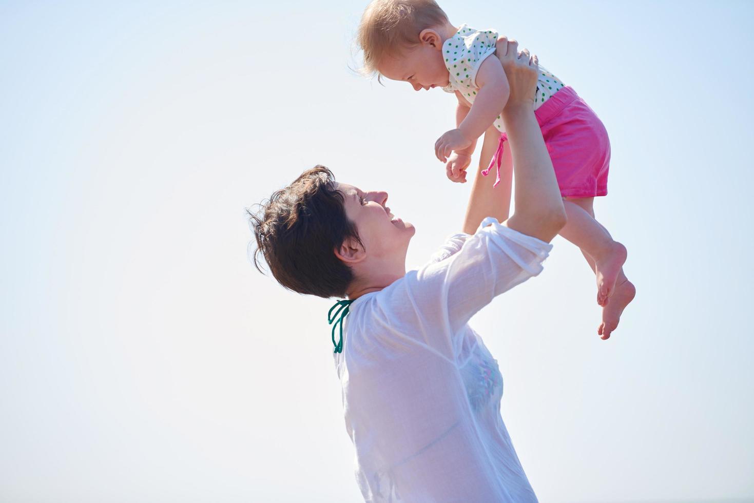 mom and baby on beach  have fun photo