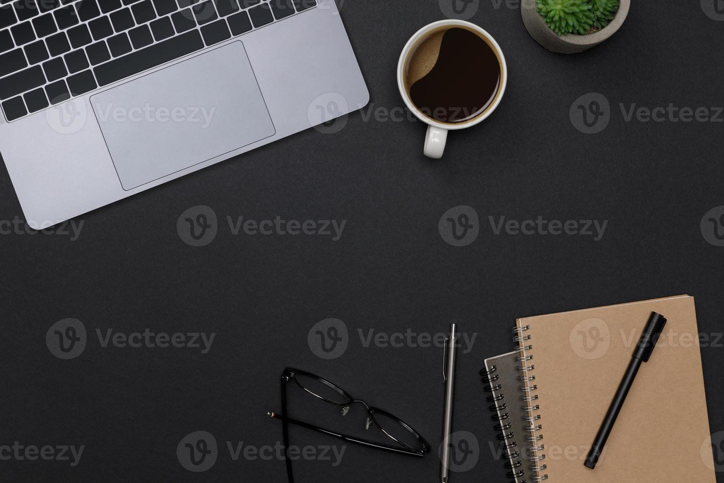 Top view workspace office supplies mockup with notebook, hot coffee cup, pen, glasses, books and accessories on black table overhead view with copy space, Workspace for new designer background photo