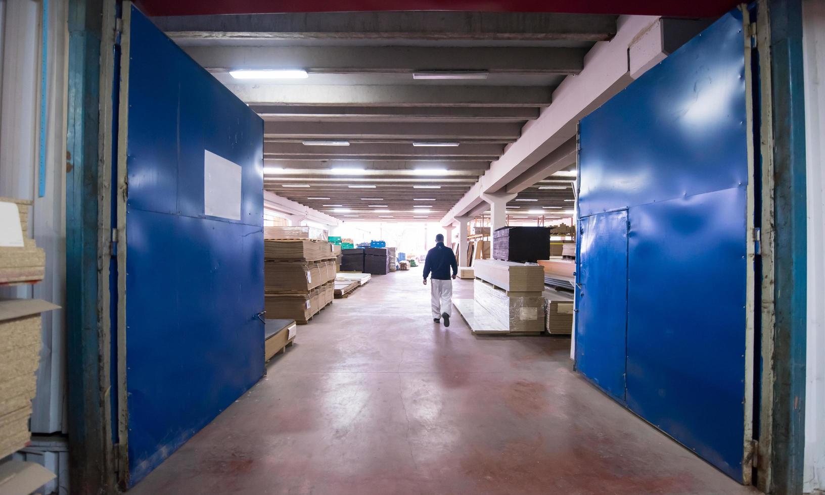 carpenter walking through factory photo