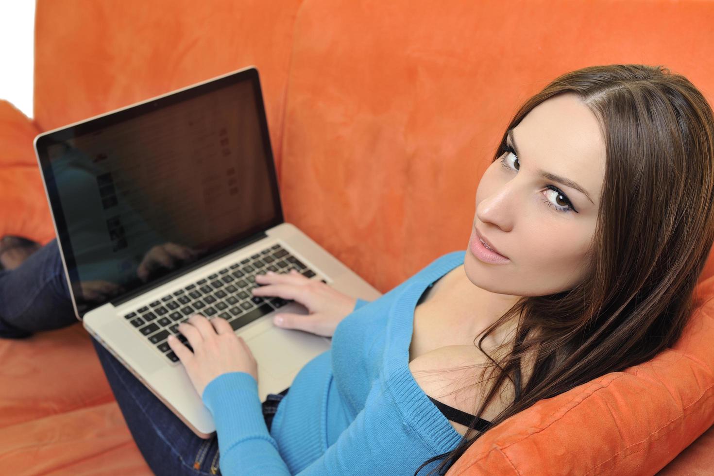 woman using a laptop computer at home photo
