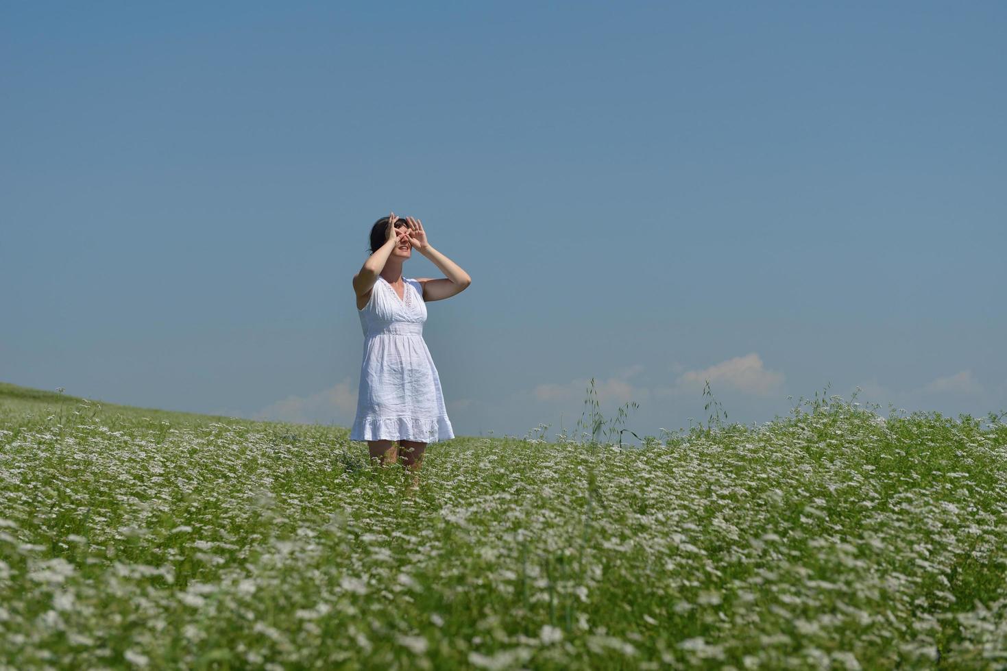 Young happy woman in green field photo