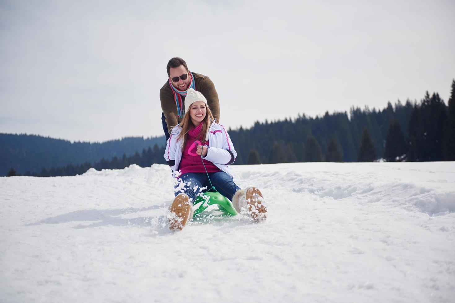 happy young couple having fun on fresh show on winter vacation photo