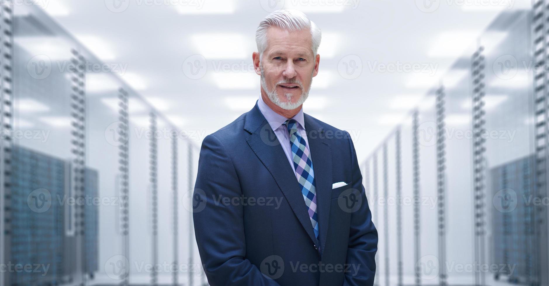 Senior businessman in server room photo