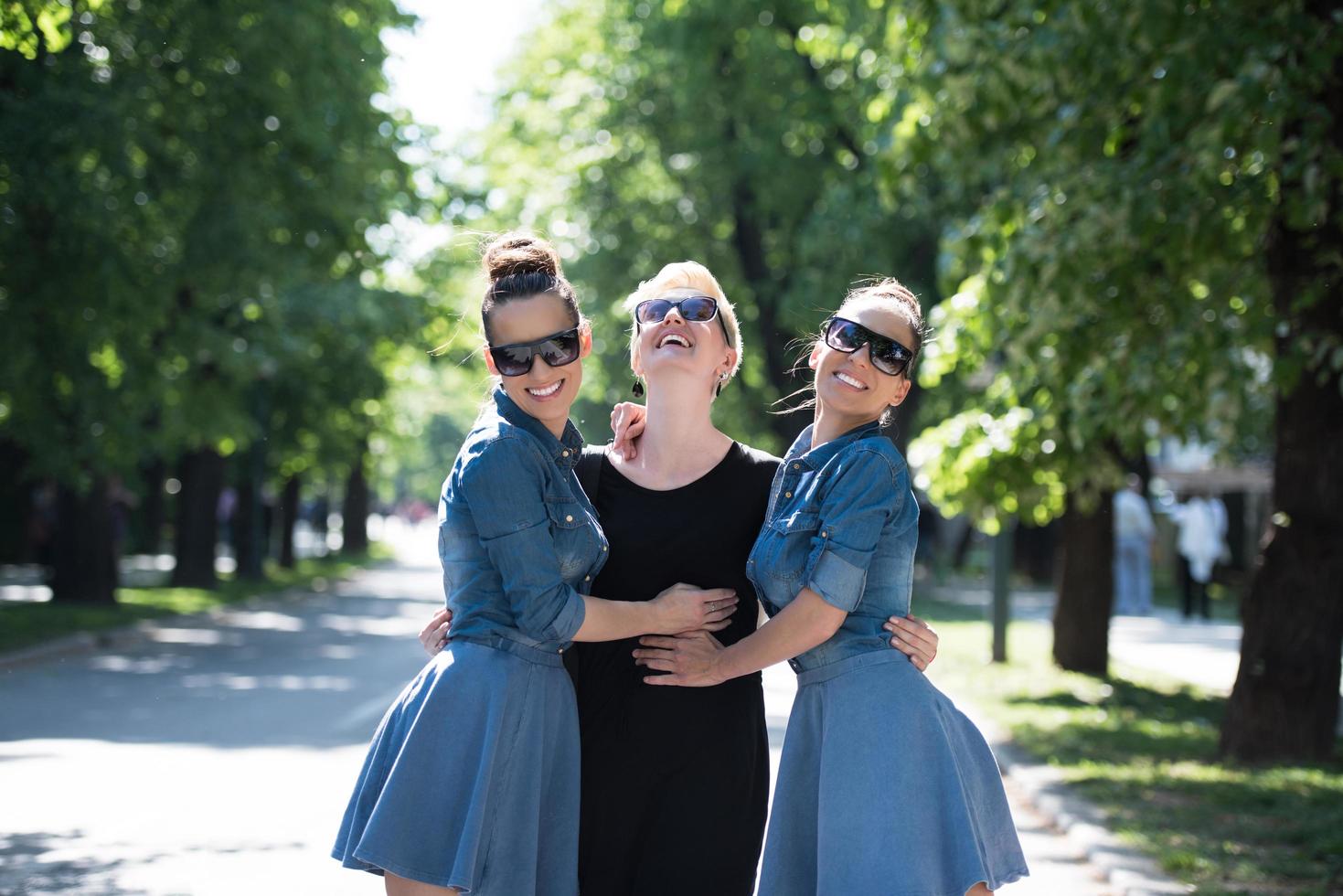 portrait of three young beautiful woman with sunglasses photo